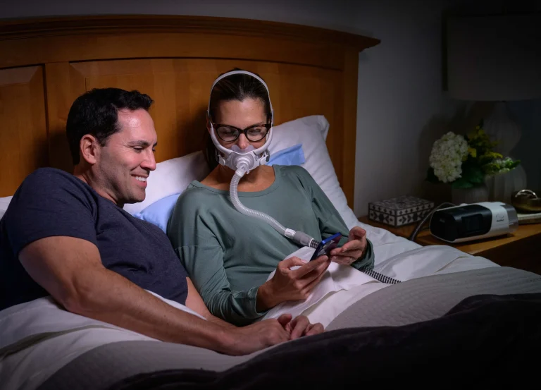 Woman using full face CPAP mask